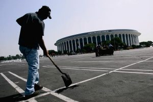 MSG, the new owner of the Forum, has paid $23.5 million for the facility and will start work this year on a $50-million renovation. The makeover is intended to turn the Forum into a top-flight concert hall and will take at least a year. Above, a worker fills potholes in the Forum’s parking lot in 2005. (Genaro Molina, Los Angeles Times / July 7, 2005)